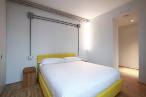 A bed or beds in a room at BasicVillage Milano
