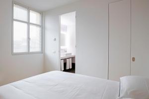 A bed or beds in a room at BasicVillage Milano