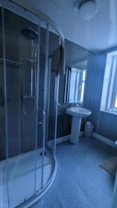 a bathroom with a shower and a sink at Dalgair House Hotel in Callander