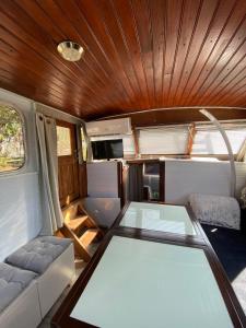 an interior view of an rv with a glass table at Bateau Fellowship in Narbonne