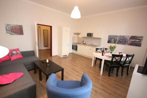 a living room with a couch and a table at Pension Alba in Görlitz
