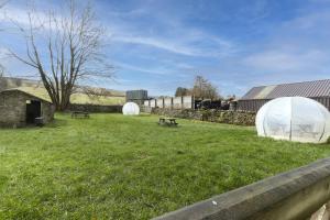 a field with two tents in the grass at H C Property - Chapel Race Countryside Retreat in Saint Johns Chapel