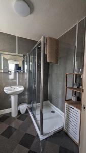 a bathroom with a shower and a sink at Dalgair House Hotel in Callander
