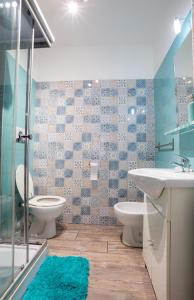 a bathroom with two toilets and a sink and a shower at DOMUS PETRI- CASA A S. PIETRO in Rome