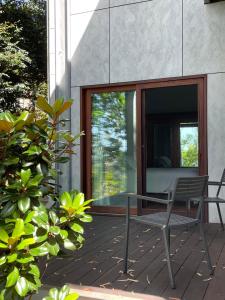 a patio with a table and a chair on a deck at Tranquil Garden Studio in Wollongong