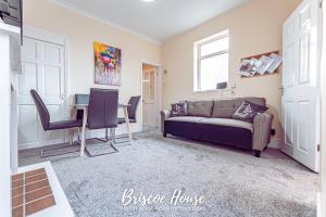 a living room with a couch and a table at Briscoe Serviced Accommodation in Manchester
