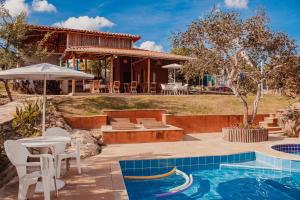 a villa with a swimming pool and a house at SO HAM Guest House in Diamantina