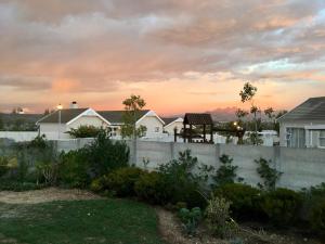 a fence in a yard with houses in the background at 22's Company in Cape Town