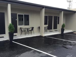 a patio with chairs and a table in a building at Original North Australian in Bowen