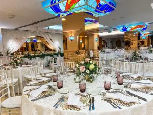 a wedding reception with white tables and white chairs at Perla Marina in Nerja