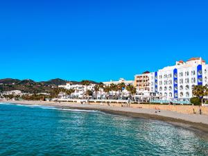 a view of a beach with buildings and the ocean at Perla Marina in Nerja