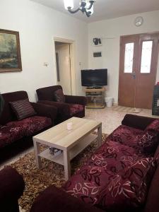 a living room with couches and a coffee table at Madaba Hills Apt in Madaba