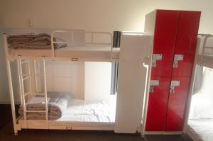 a room with two bunk beds and a red cabinet at One Way Guesthouse Busan in Busan