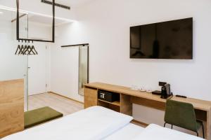 TV in/ali zabaviščno središče v nastanitvi BEE GREEN Linz Self-Check-in-Hotel