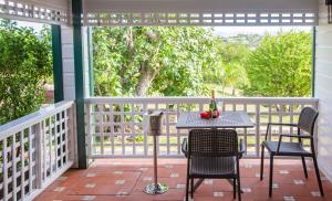 a patio with a table and chairs on a porch at Weatherills Hotel in Cedar Grove