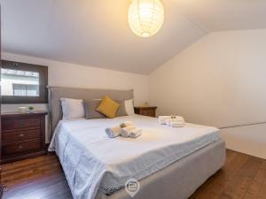 a bedroom with a large bed with two towels on it at Sun & Sea Studio in Tortolì