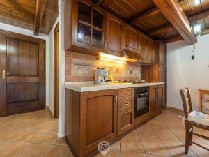 a kitchen with wooden cabinets and a counter top at Sun & Sea Studio in Tortolì
