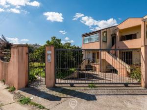 a gate in front of a house at Sun & Sea Studio in Tortolì