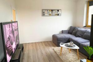 a living room with a couch and a table at 2-room apartment with balcony in Meckenheim