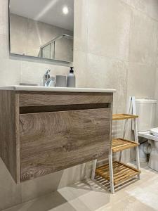 a bathroom with a sink and a mirror at Cosy one bedroom Apartment 3 by Solea in San Ġwann