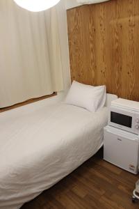 a small room with two beds and a window at Hostel JL in Chung-jeong in Seoul