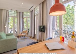 a living room with a table and a large window at Gòtic by The 5ve Soul in Barcelona