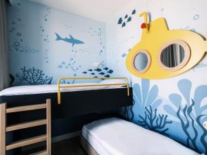 a childs bedroom with a submarine wall mural at Falkensteiner Family Hotel Diadora in Zadar