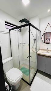 a bathroom with a shower and a toilet and a sink at "Perto do Mar", Aconchego no Coração da Vila! in Porto De Galinhas