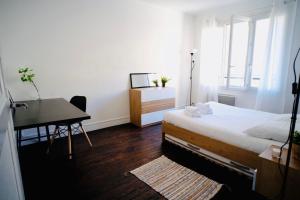 a bedroom with a bed and a desk and a desk at City center Caen in Caen