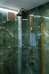 a bathroom with a shower with green tiles at Şebnem Hotel in Istanbul