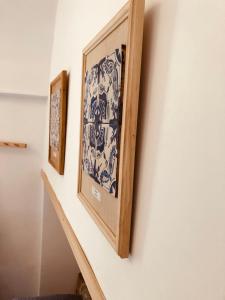 a stairwell with two framed pictures on a wall at A casa dei Sasso, Laetitia Suite in Positano