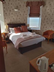 Un dormitorio con una cama grande y una ventana en Tyr Graig Castle, en Barmouth