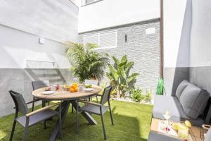 a patio with a table and chairs on the grass at Sunny island terraza san andrés in San Andrés