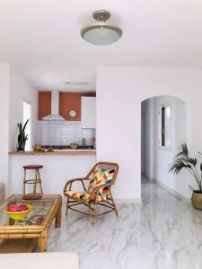 a living room with a chair and a table at Casa Nicolás in Playa Honda