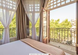a bedroom with a bed and a large window at Gòtic by The 5ve Soul in Barcelona