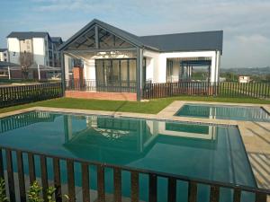 a house with a swimming pool on a roof at The Aura in Roodepoort