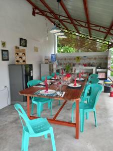 a table and chairs in a room with a kitchen at Happy bear moalboal budget rooms in Moalboal