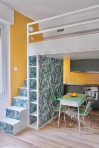 łóżko na podwyższeniu w kuchni ze stołem i krzesłami w obiekcie La Maison City Life Apartments w Mediolanie