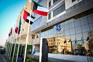 a building with several flags in front of it at sas blue suites in Jeddah