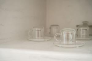 a row of cups and plates on a shelf at AKRI santorini with heated jacuzzi in Emporio Santorini