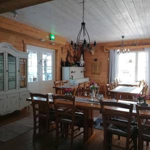 a dining room with a table and chairs at Hotel Uitonniemi in Kemijärvi