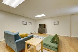 a living room with a couch and a table at Waterfront Lakes Region Home on Private Cove! in Alton Bay