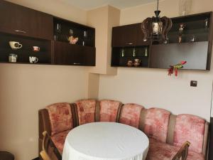 a dining room with a white table and chairs at Dabnika in Vratsa