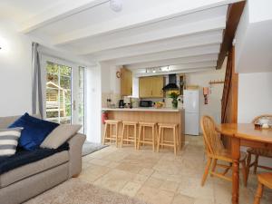 a living room with a couch and a table at Small Barn in Liskeard