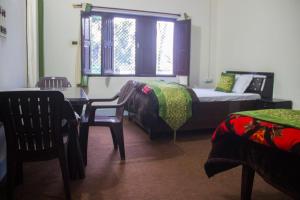 Ένα ή περισσότερα κρεβάτια σε δωμάτιο στο Aranyam Home Stay