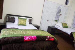 Ένα ή περισσότερα κρεβάτια σε δωμάτιο στο Aranyam Home Stay