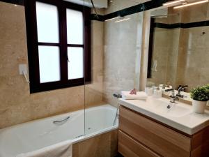 a bathroom with a tub and a sink and a shower at Glory Home II Catedral in Zamora