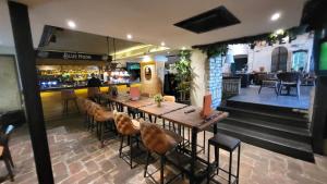 a restaurant with a long wooden table and chairs at Design Hotel Mr President in Belgrade
