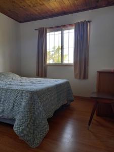 Un pat sau paturi într-o cameră la Cabaña El Encuentro