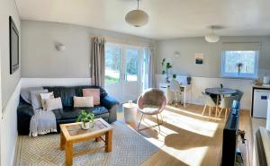 a living room with a couch and a table at Homestead Cottage, Fort Augustus in Fort Augustus